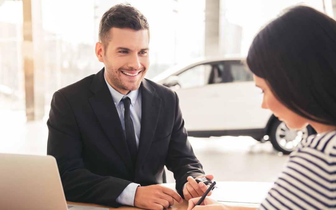 A dealership finance manager presenting different product options to a customer. A key skill to showcase on an automotive finance manager resume.